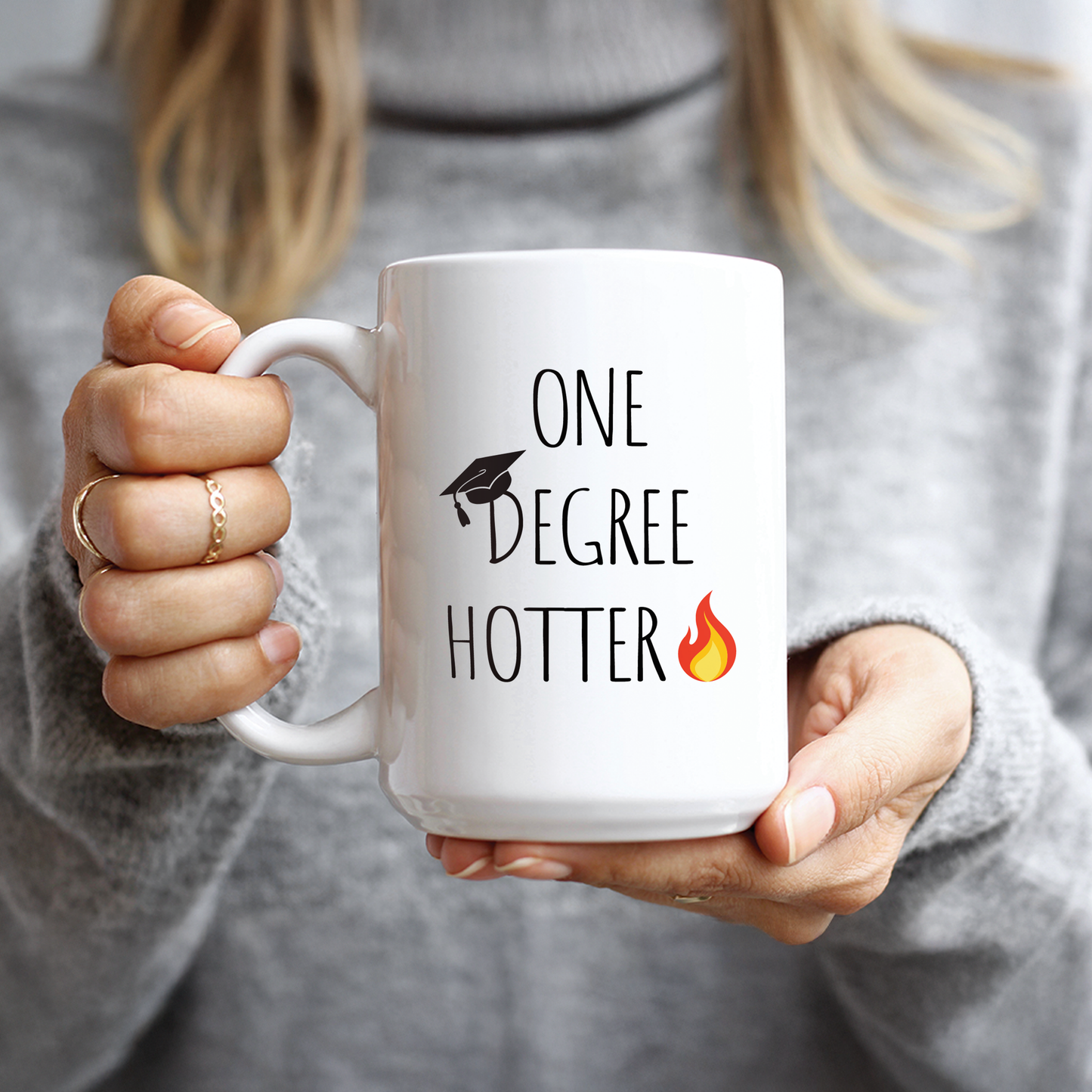 Hand holding funny college graduation gift coffee cup