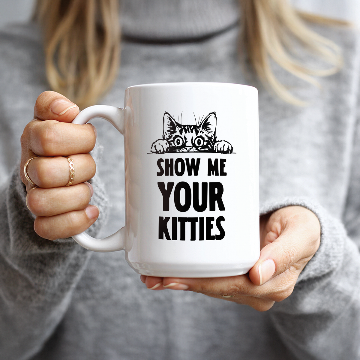 Hand holding peeking cat and Show Me Your Kitties text coffee mug