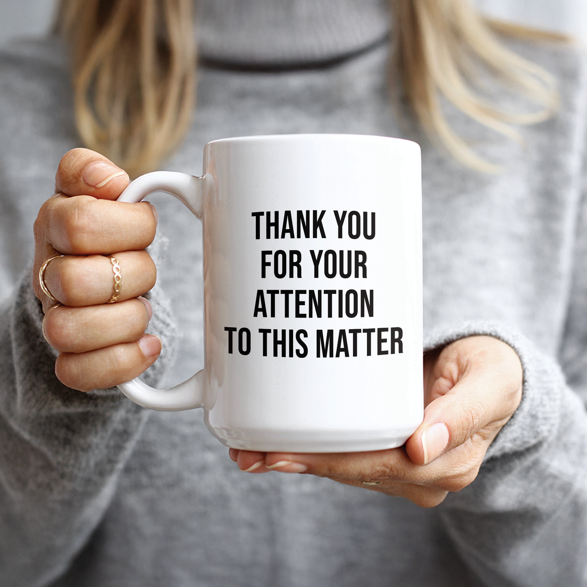 Hand holding Thank You For Your Attention To This Matter text coffee mug