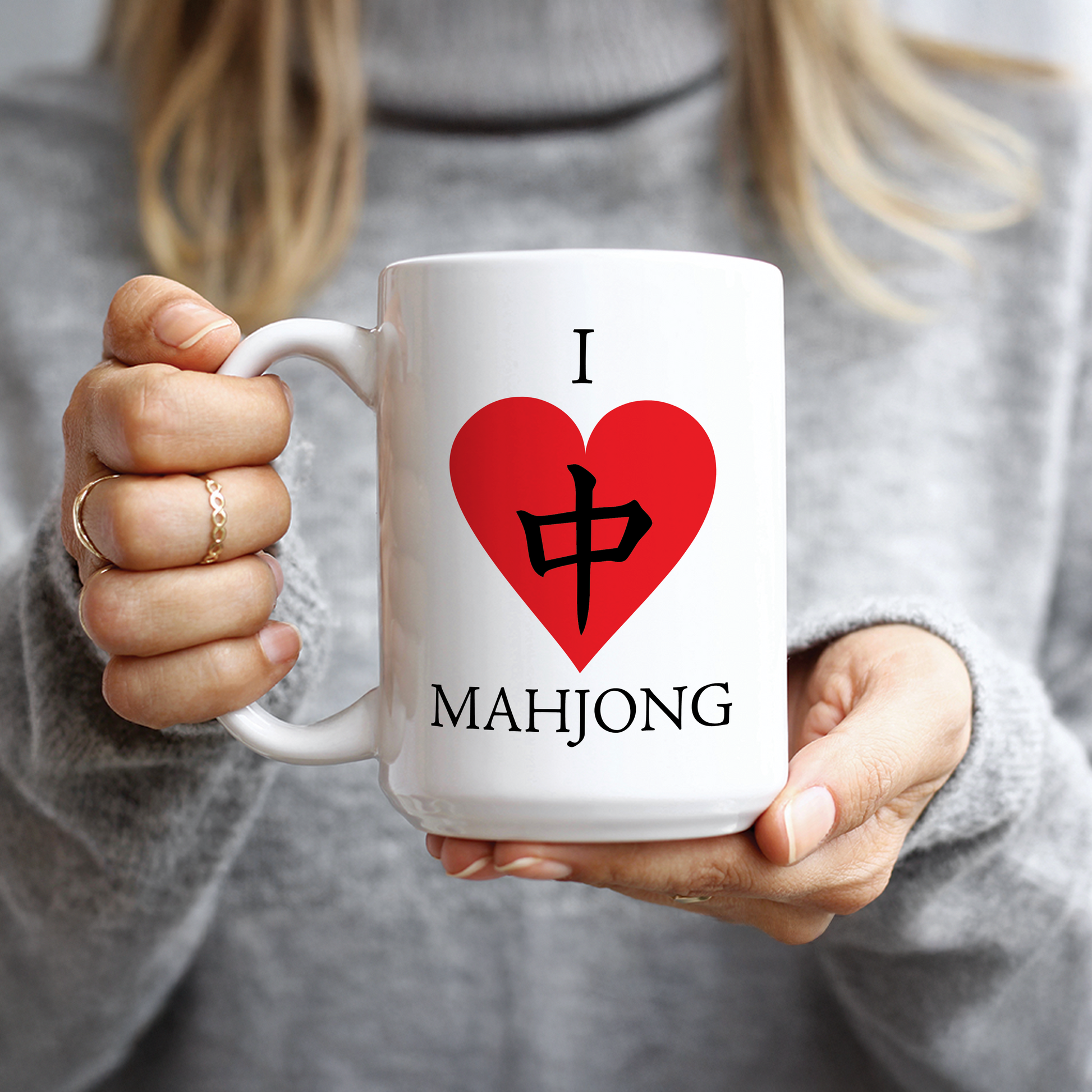 Hand holding white mug with Red Dragon heart design