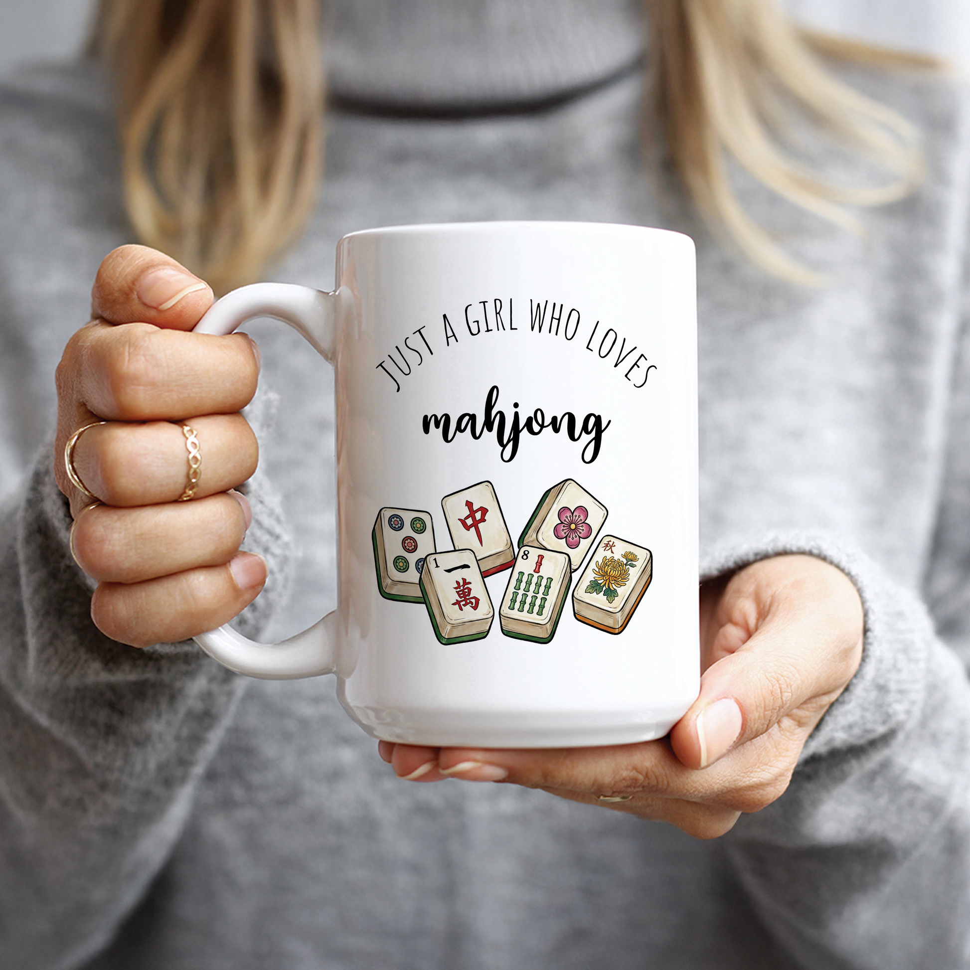Hand holding white mug with Just A Girl Who Loves Mahjong design